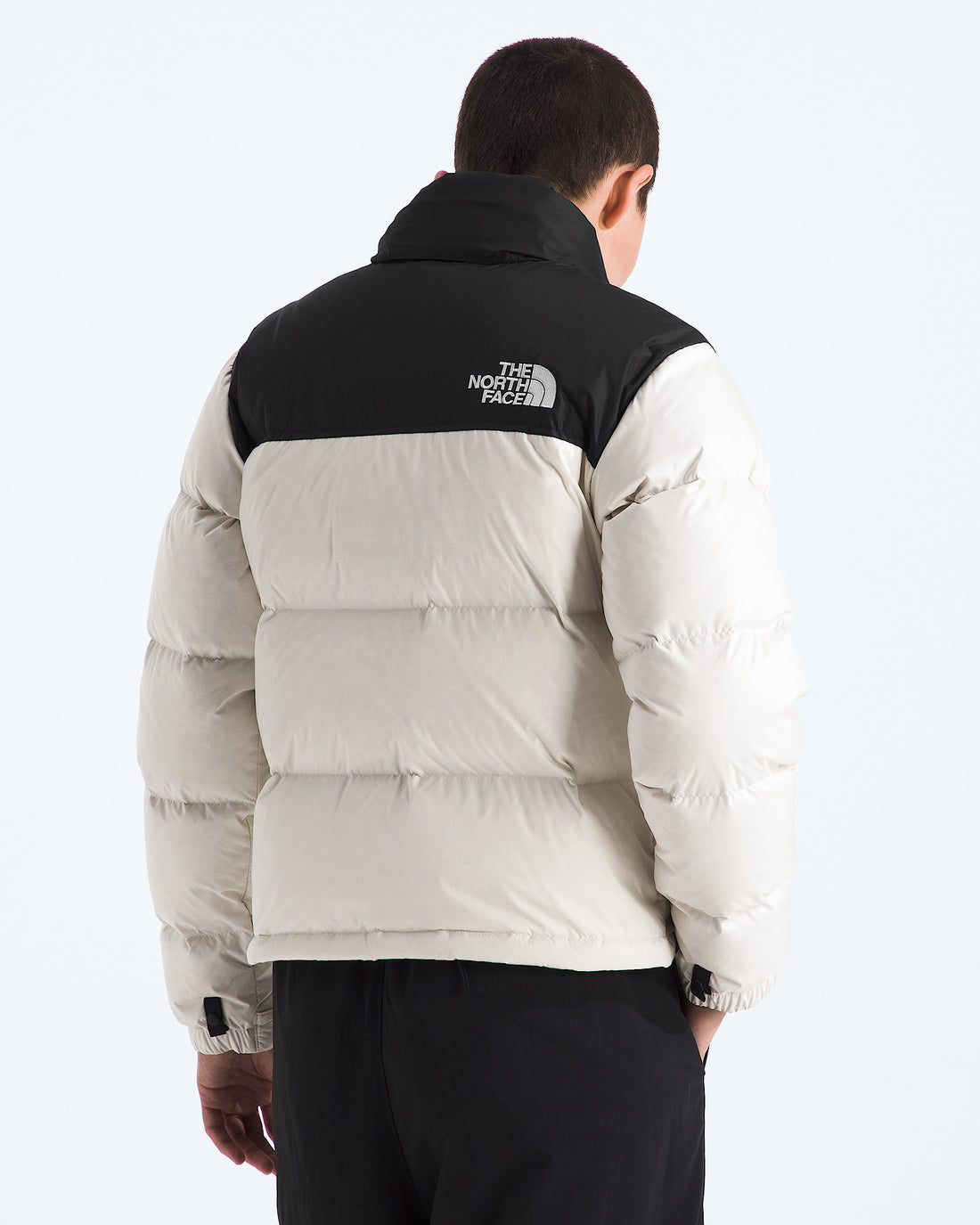 The North Face Women’s 1996 Retro Nuptse Jacket in White Dune/TNF Black/Recycled Down, back view