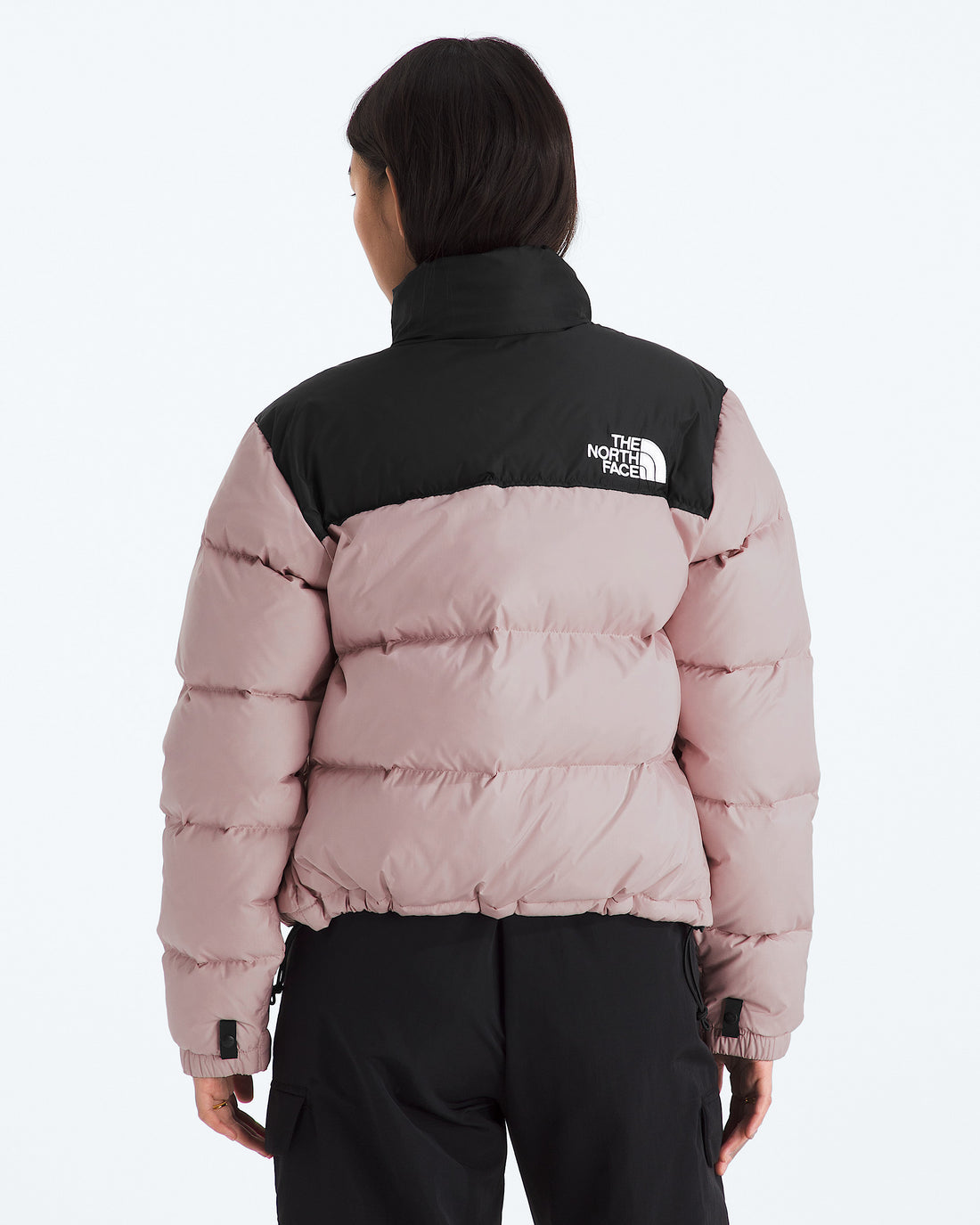 The North Face Women’s 1996 Retro Nuptse Jacket in Metal Pink/TNF Black, back view