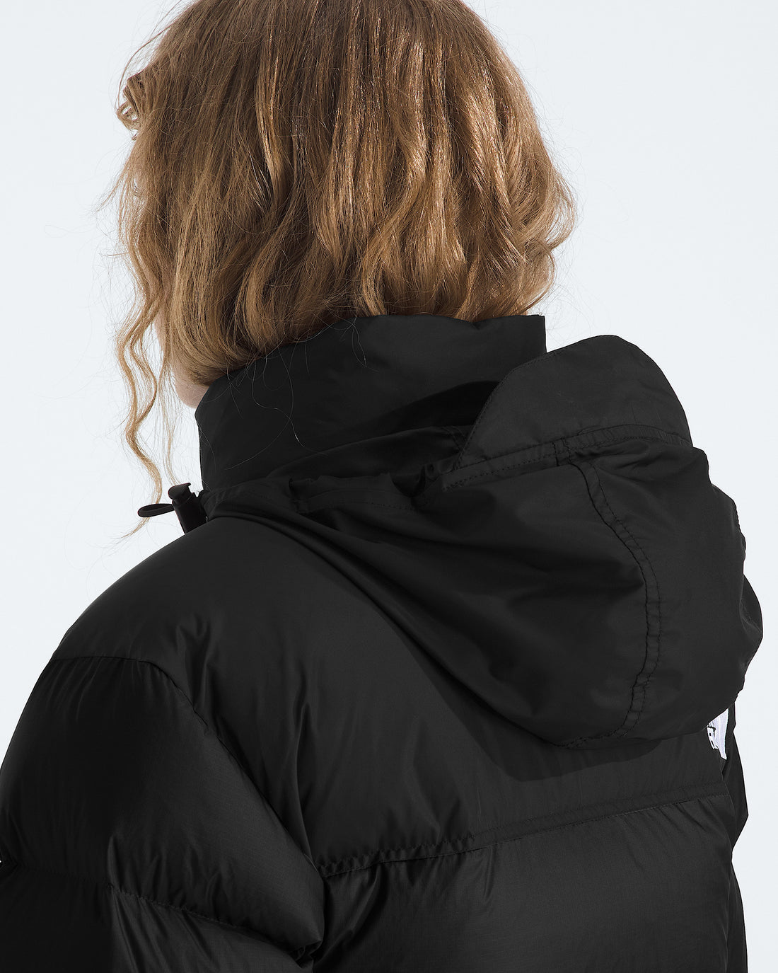The North Face Women’s 1996 Retro Nuptse Jacket in TNF Black/Recycled Down, stowable hood detail