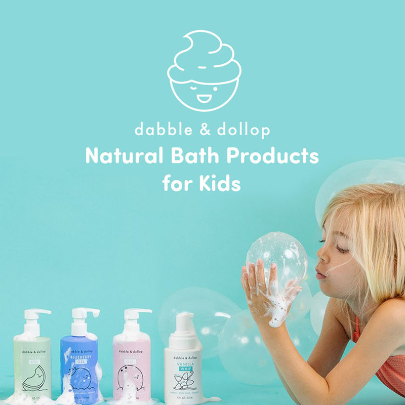 Dabble & Dollop natural kids bath products with foaming soap bottles and child blowing bubbles