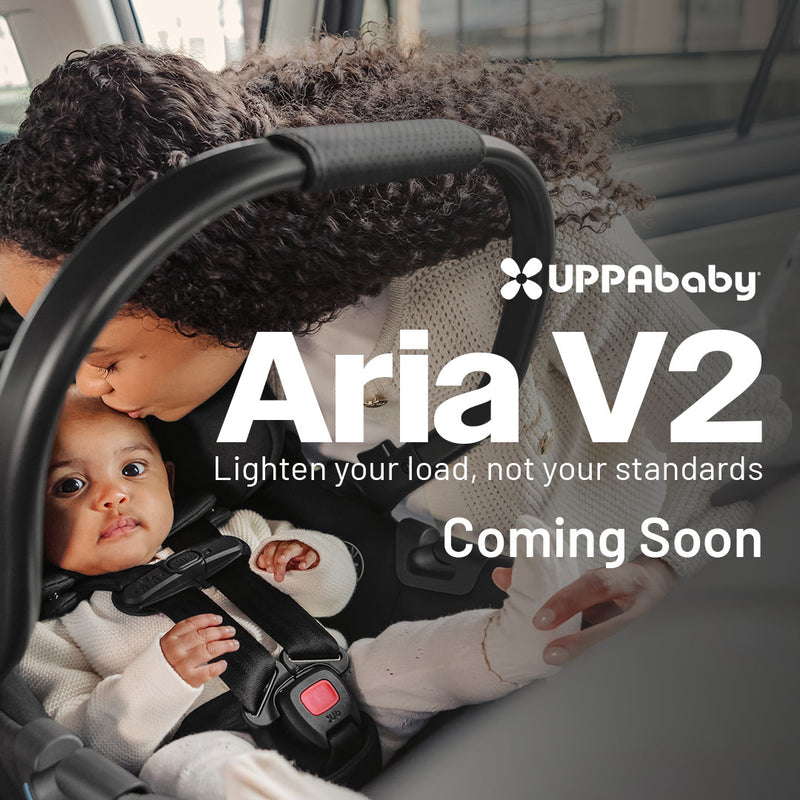 UPPAbaby Aria V2 lightweight infant car seat rear-facing in car with parent close-up lifestyle scene