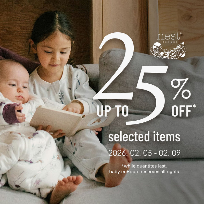 Nest Designs baby clothing sale with two children in organic cotton sleepwear, up to 25 percent off selected items
