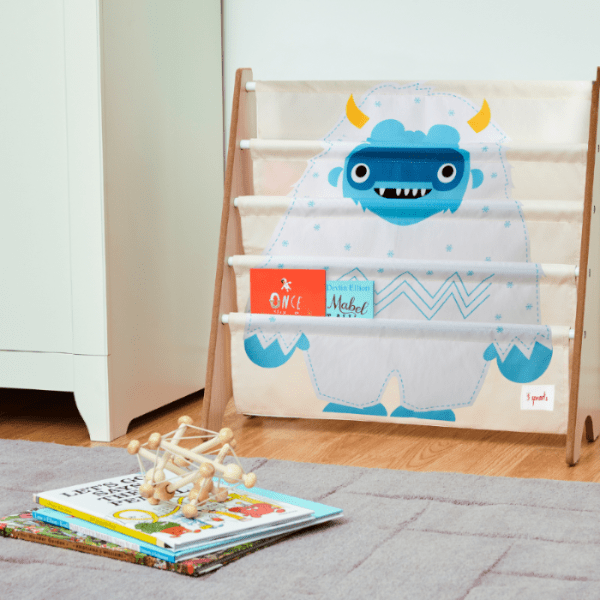3 Sprouts wooden book rack with blue monster print for a cozy nursery reading nook