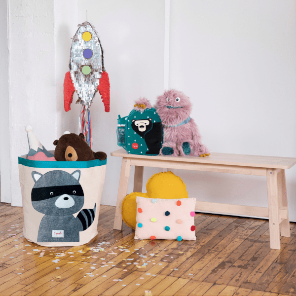 3 Sprouts lunch bag teal with animal print, shown on a bench beside plush toys