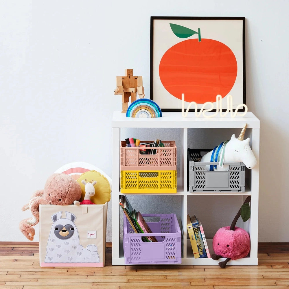 3 Sprouts folding clay storage crate set — four pastel crates with built-in handles on a white cubby shelf