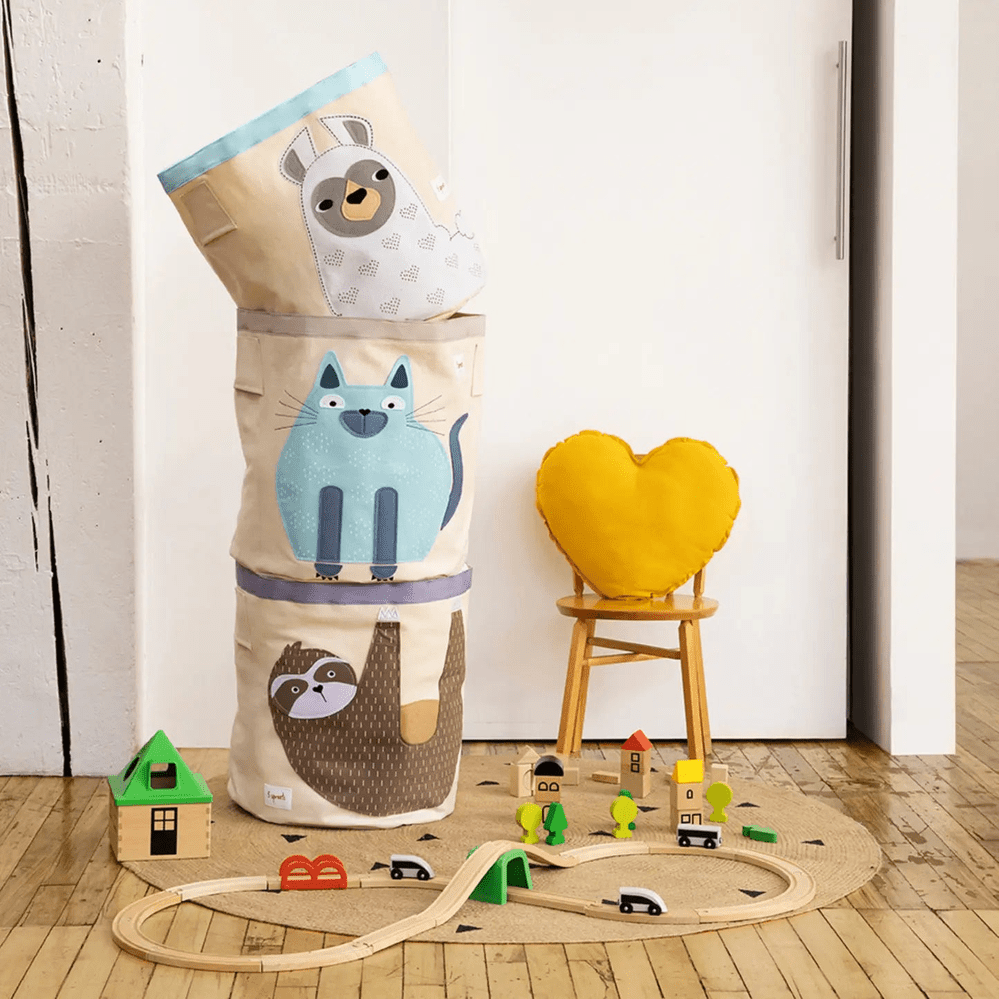 3 Sprouts Storage Bin stack in beige fabric with blue cat and gray raccoon prints, stacked for kid-friendly toy storage.
