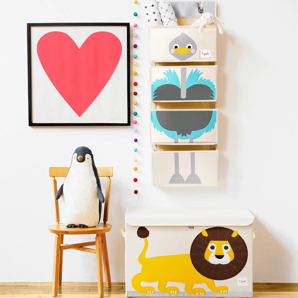 3 Sprouts Toy Chest, white with colorful animal panels; stacked boxes hang on wall while a lion chest sits below.