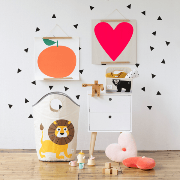 3 Sprouts laundry hamper, white fabric with lion print, in a bright nursery.