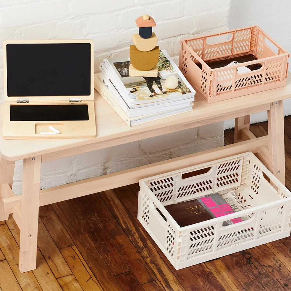 3 Sprouts Modern Folding Crate Clay on a light wood desk with magazines and cream storage crates