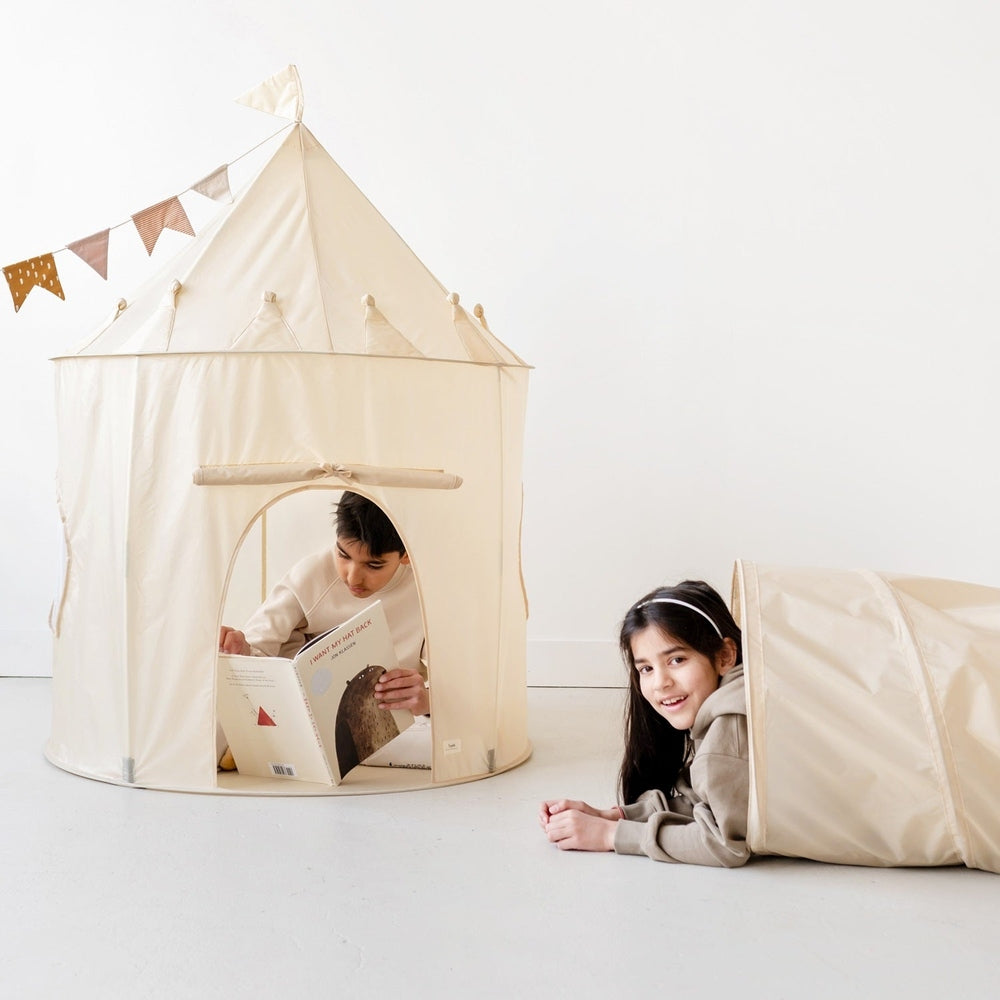 3 Sprouts Recycled Fabric Play Tunnel in natural beige with kids playing nearby and reading inside.