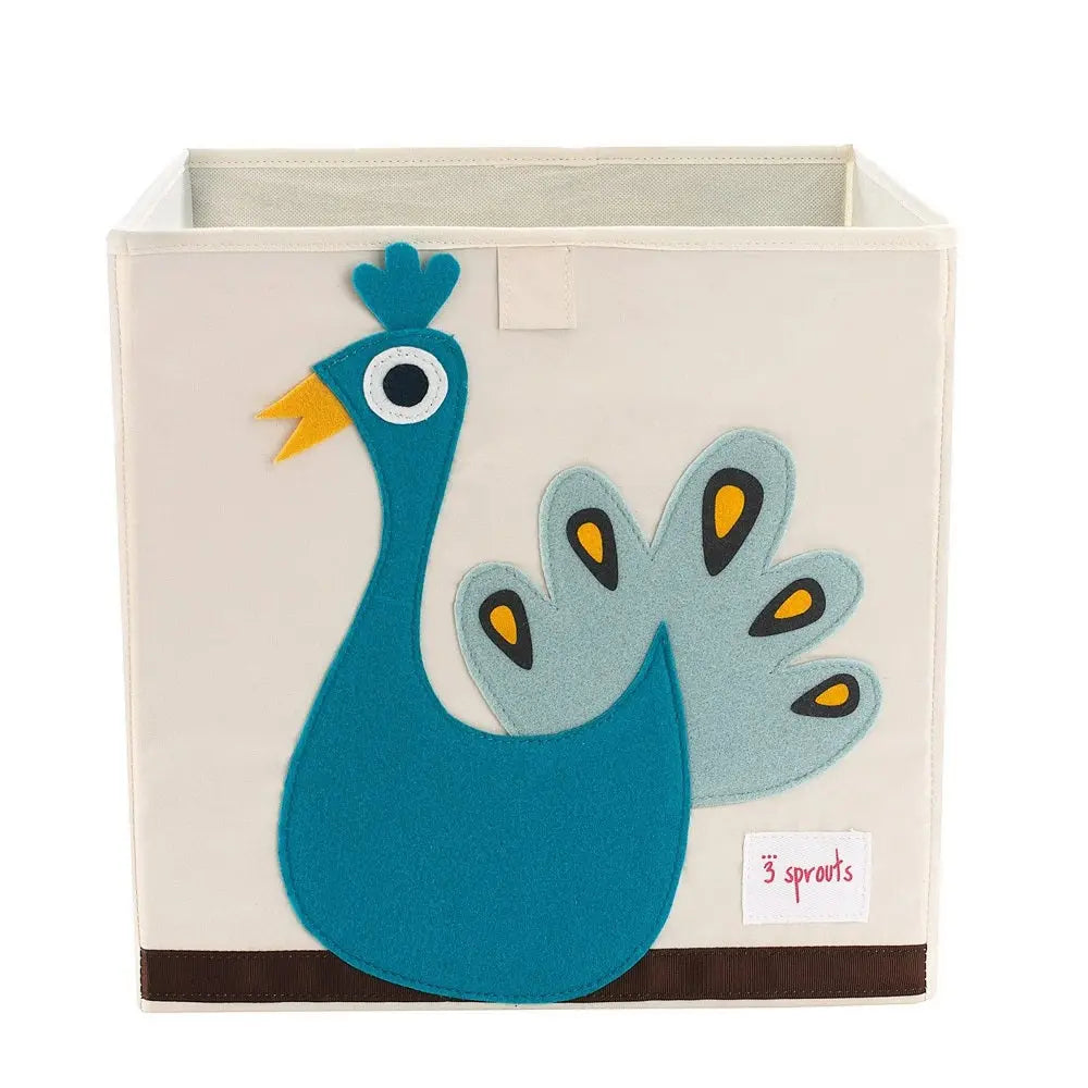 3 Sprouts Storage Box in cream with a teal peacock applique, helping keep nursery organized.
