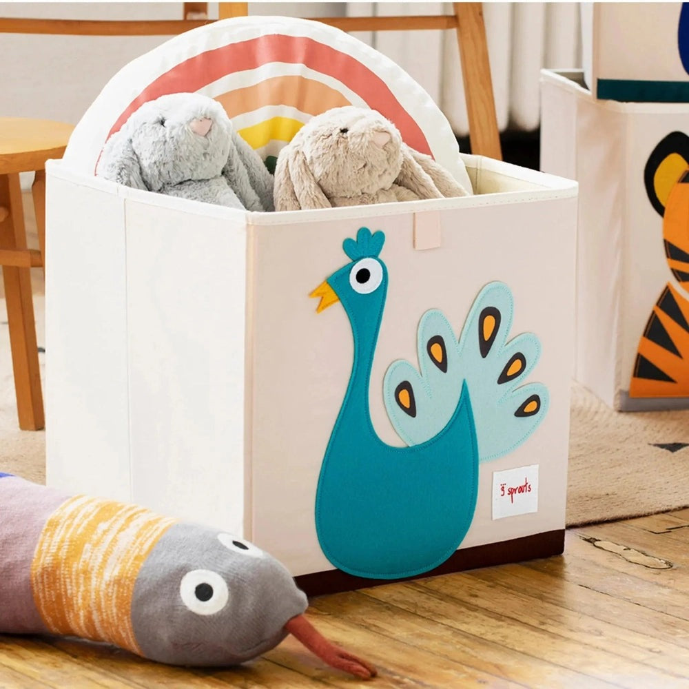 3 Sprouts Storage Box white with blue peacock applique, storing two plush rabbits.