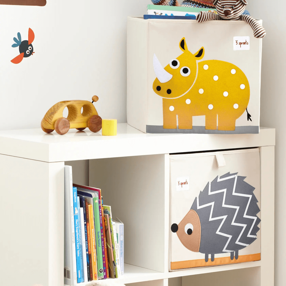 3 Sprouts Storage Box set of two white cubes with yellow rhinoceros and zigzag hedgehog prints, neatly on a shelf.
