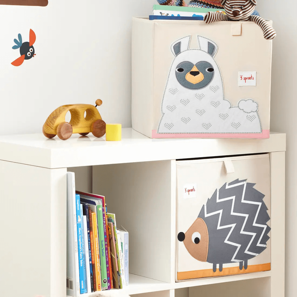 3 Sprouts Storage Box set on a white shelf; beige llama box and hedgehog box keep the nursery tidy.
