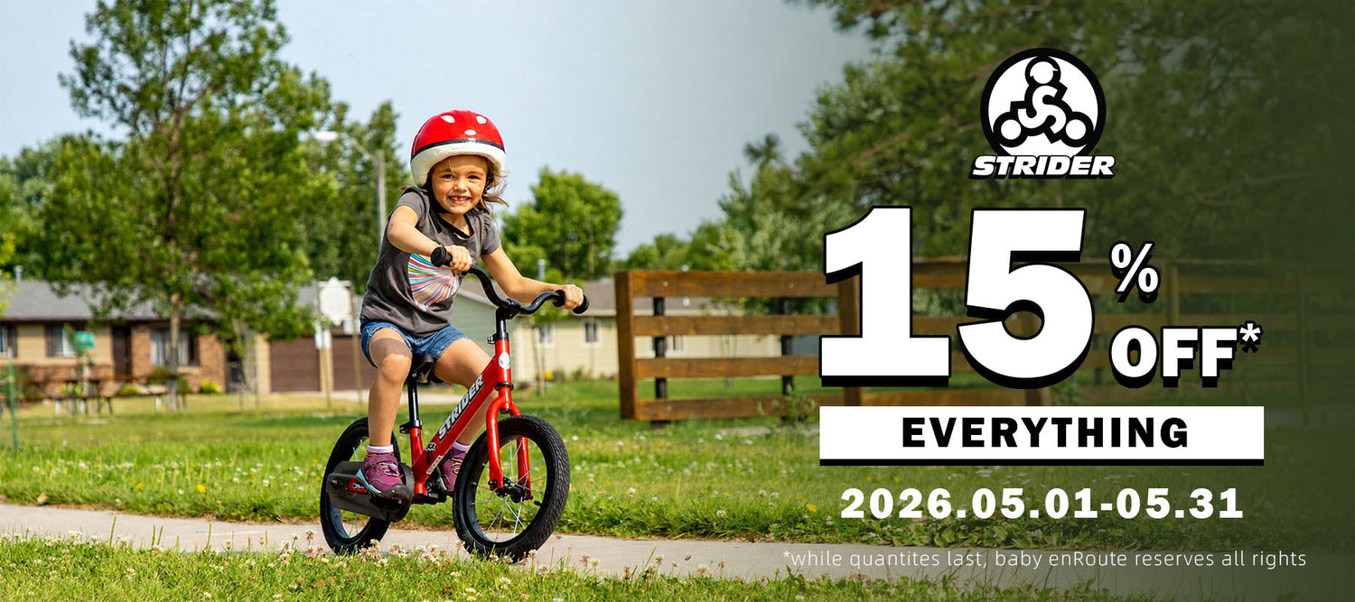 Strider Balance Bike in Red with toddler riding outdoor neighborhood lifestyle view horizontal