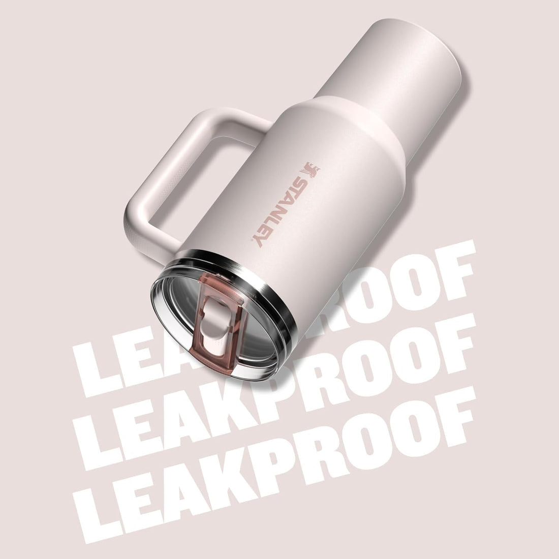 Stainless steel tumbler with handle on a light pink background, featuring the brand 'S'ANLY'.