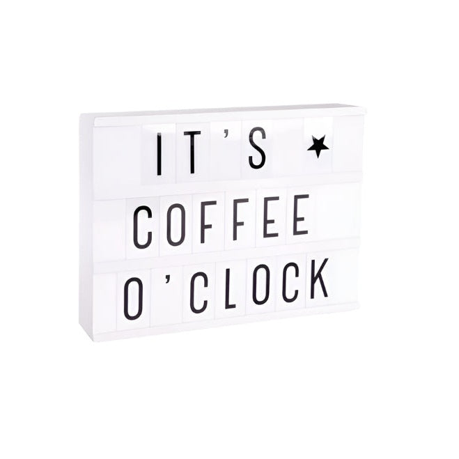 A Little Lovely Company lightbox, white with black letters reading IT'S COFFEE O'CLOCK