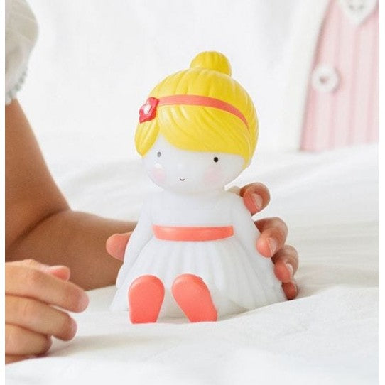 A Little Lovely Company Little Light Fairy night light with a white dress, pink accents, and yellow hair.