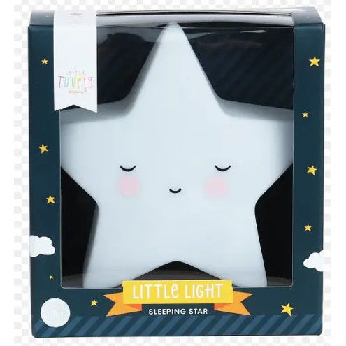 A Little Lovely Company Little Night Light star-shaped night light glows softly, white with pink cheeks, in a blue starry box.