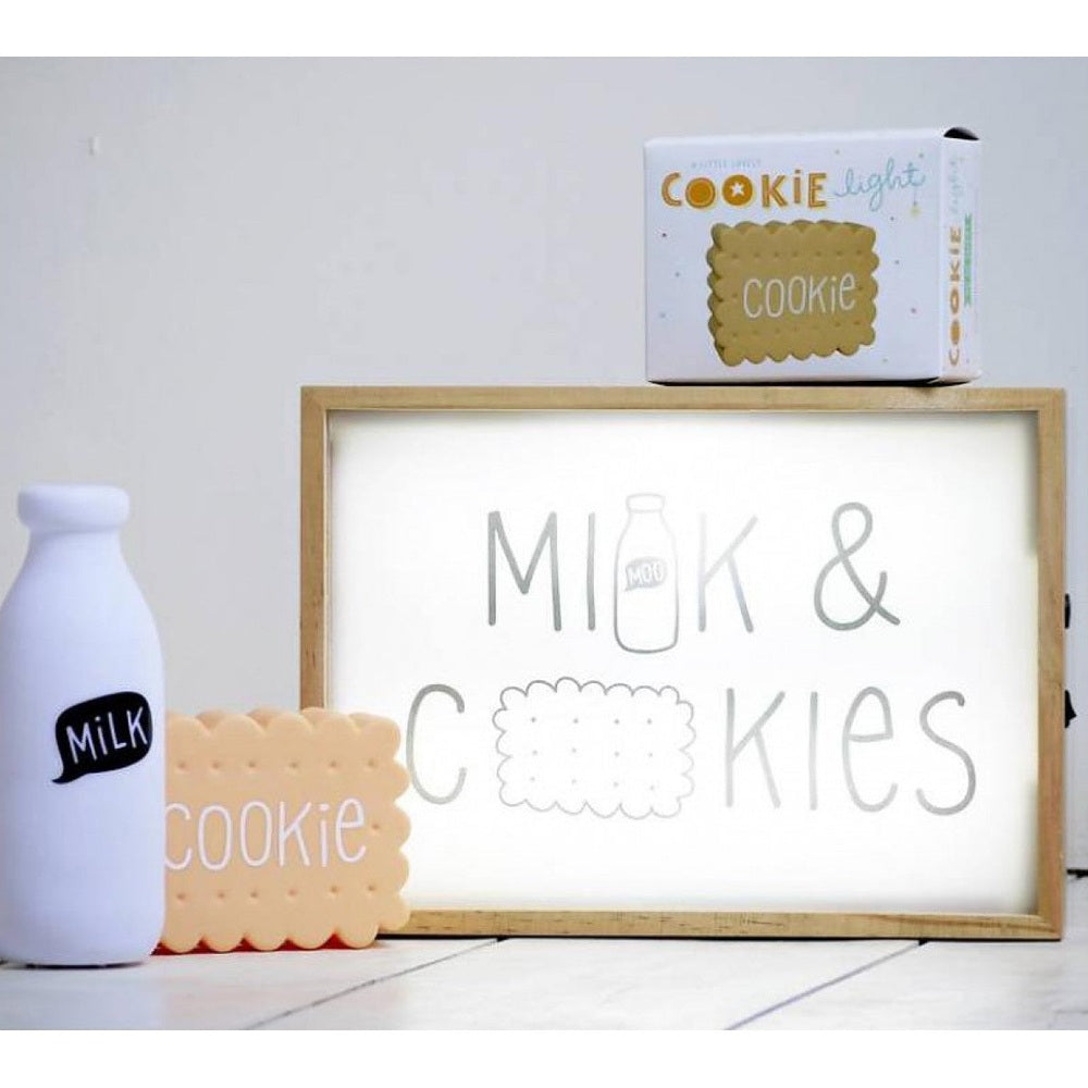 A Little Lovely Company Mini Milk Light with beige scalloped cookie prop and white milk bottle decor on a light sign