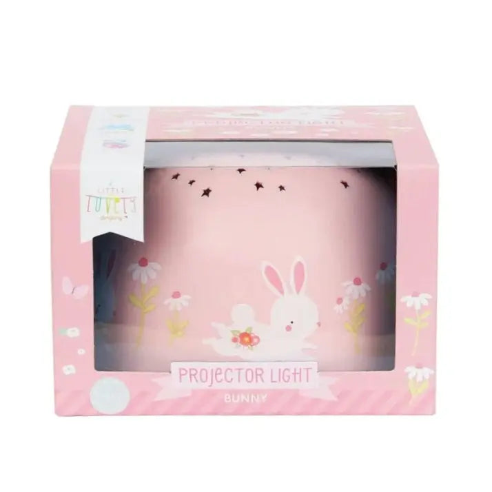 A Little Lovely Company Projector Night Light in pink, projecting a bunny and flowers scene for bedtime.