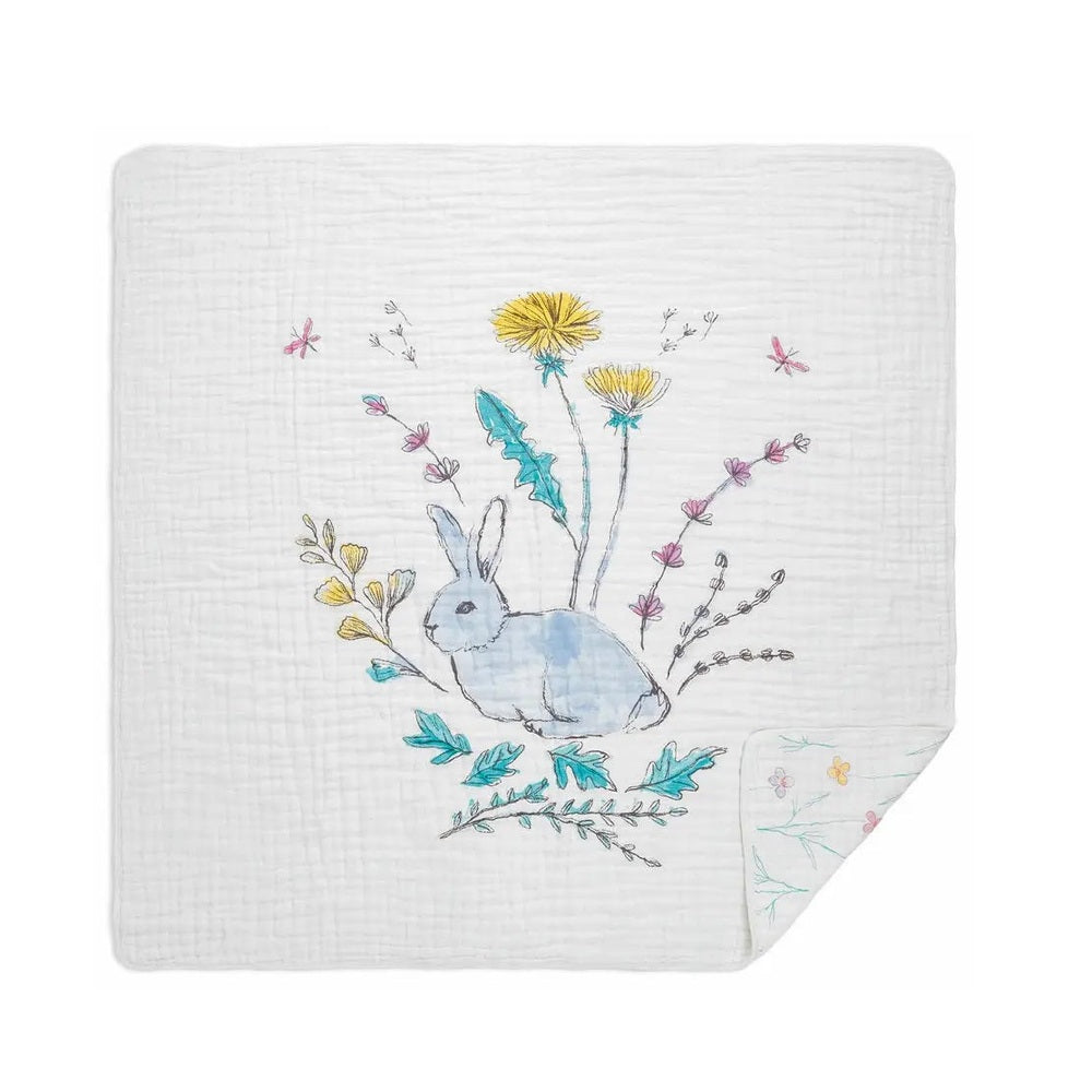 Aden+Anais Classic Dream Blanket in white muslin with a blue watercolor rabbit among flowers, showcasing soft breathability.