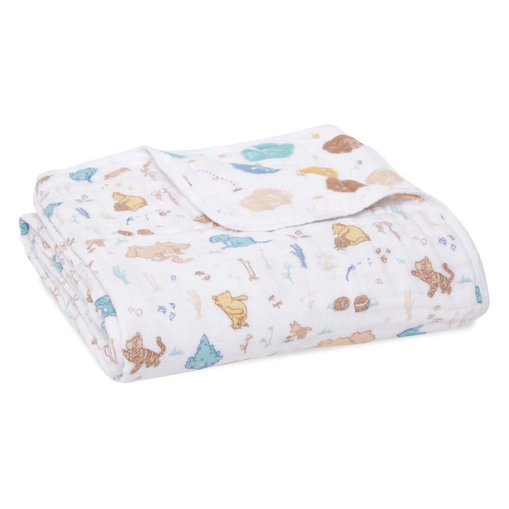 Aden+Anais Classic Dream Blanket white baby blanket softly folded to reveal pastel animal prints.