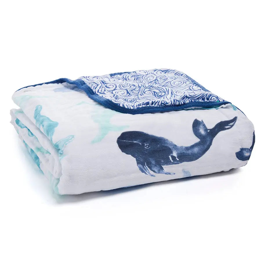Aden+Anais Classic Dream Blanket, white muslin with navy whale print, rolled for display
