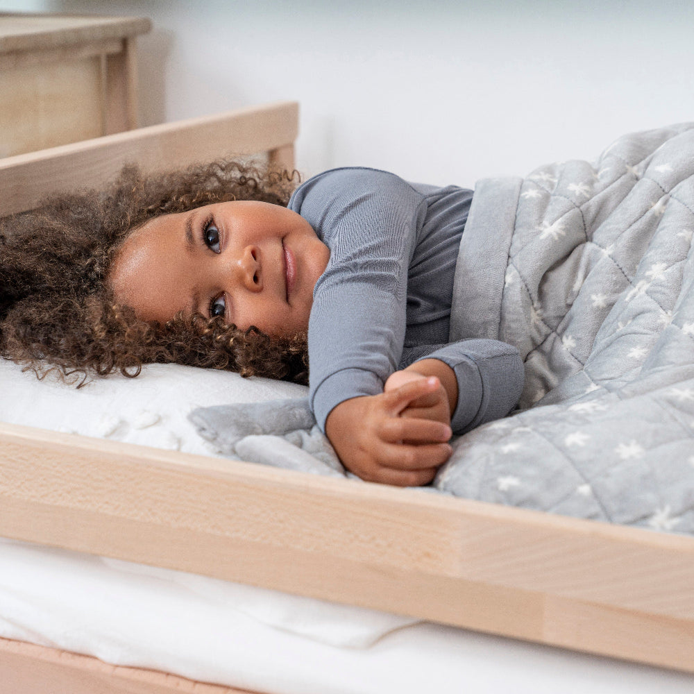 Aden+Anais Embrace Winter Sky Weighted Toddler Blanket; grey quilt with star pattern
