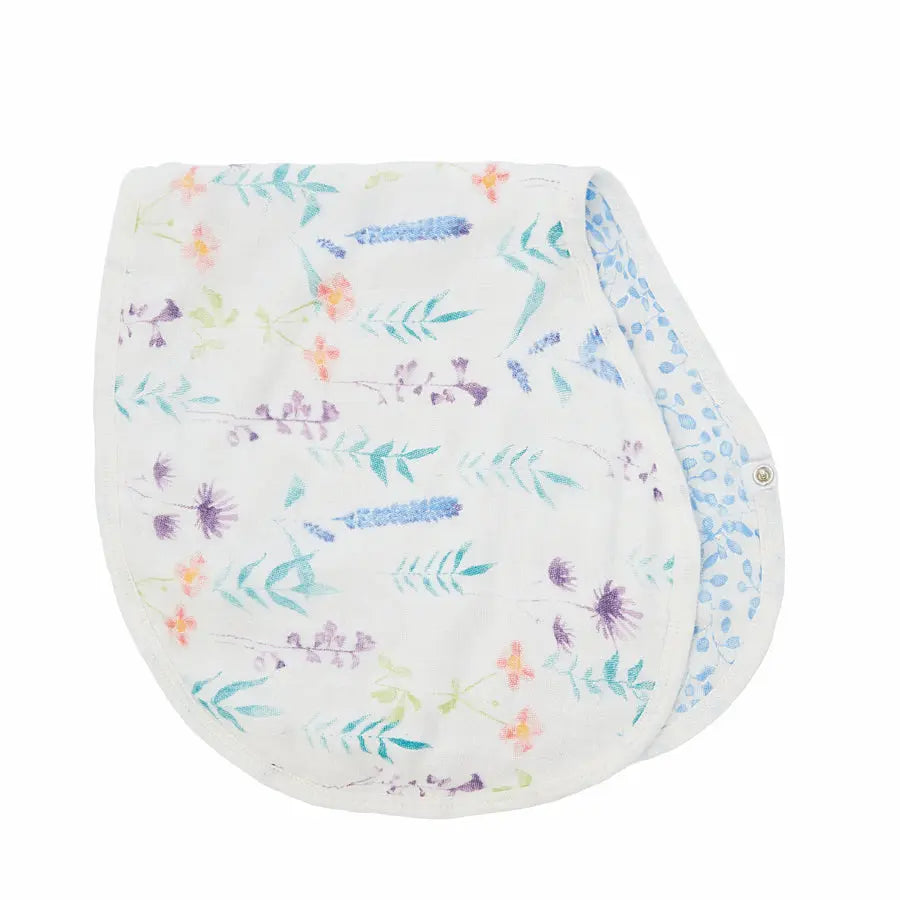 Aden+Anais Silky Soft Burpy Bib in pastel floral print, white fabric with snap closure shown ready for mealtime.