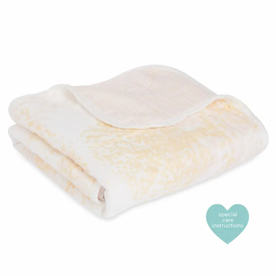 Aden+Anais Silky Stroller Blanket, ivory cream with plush silky fabric neatly folded for easy snuggling.