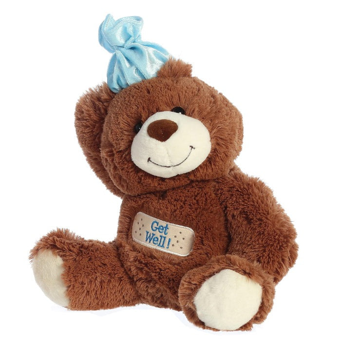 Aurora Get Well Bear 12-inch stuffed animal with brown fur, blue bow, beige muzzle, and Get Well patch.