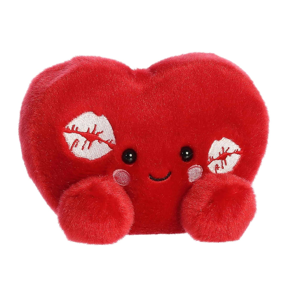 Red heart-shaped plush palm pal with fluffy paws, black button eyes, smiling mouth, and white stitched patches on the sides.