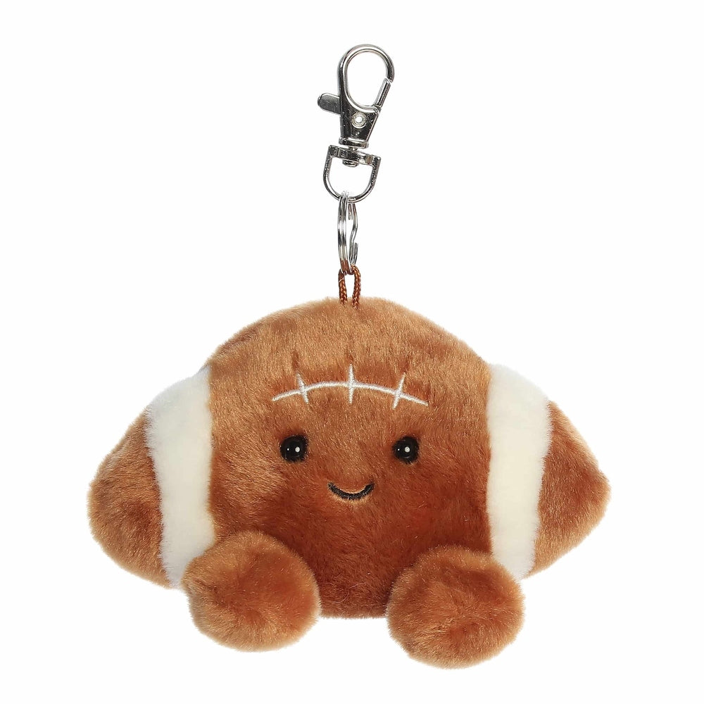 Aurora Palm Pals tackle football clip-on plush, brown with white laces, cheerful face