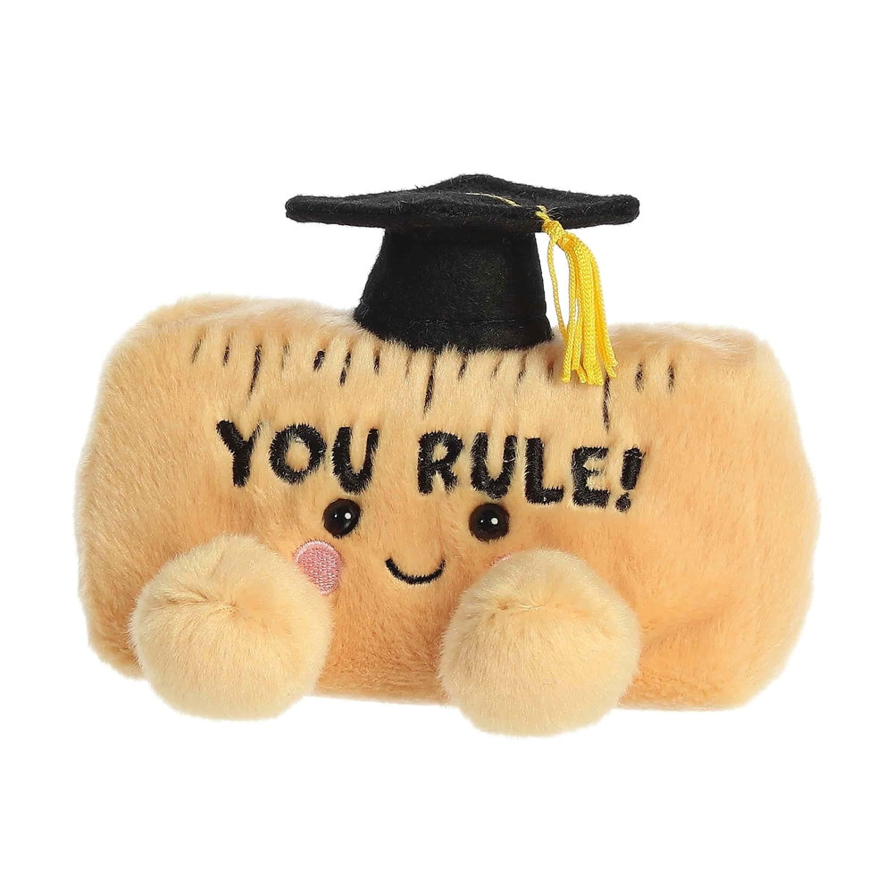 Aurora Palm Pals You Rule 5-inch plush ruler toy in tan with black graduation cap and yellow tassel.
