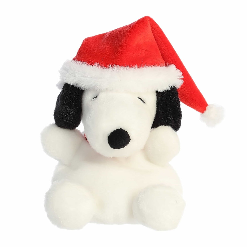 Aurora Peanuts Palm Pals Santa Snoopy plush toy wearing a red Santa hat, fluffy white body with black ears.