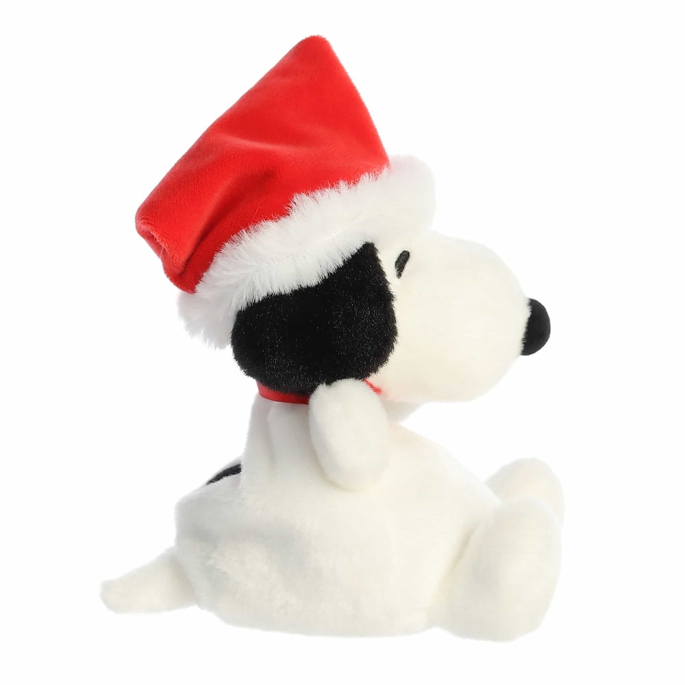 Aurora Peanuts Palm Pals Santa Snoopy 5" plush sits wearing a red Santa hat with fluffy white trim.