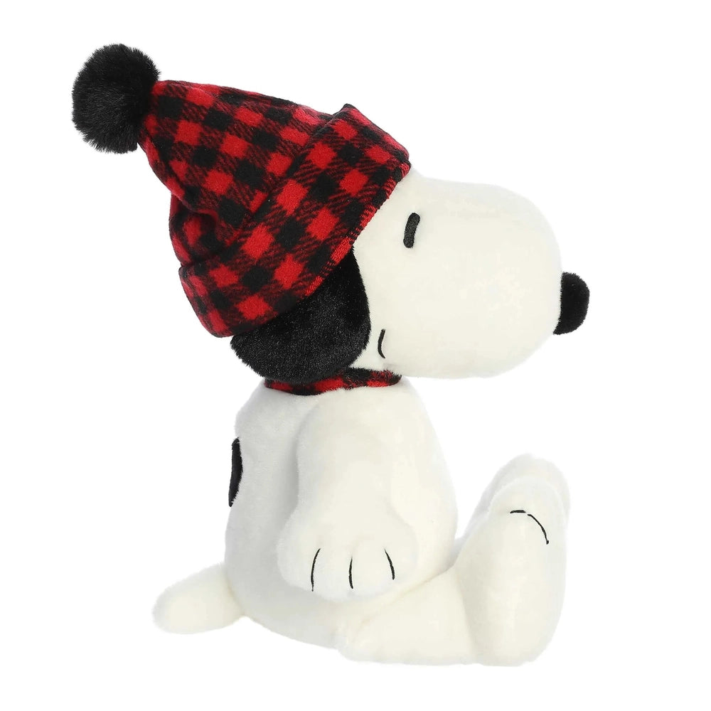 Snoopy plush wearing a red plaid winter hat, sitting cozily in this Aurora 11" stuffed animal.