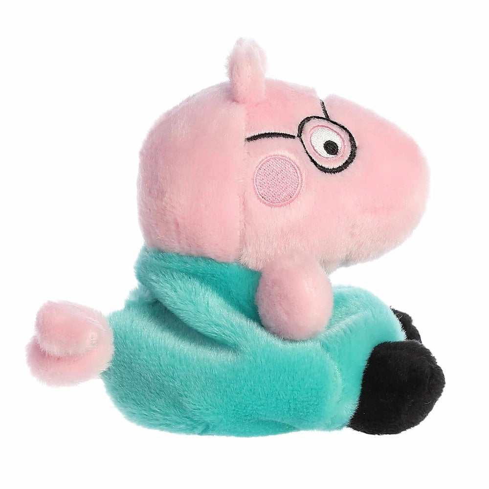 Aurora Peppa Pig Daddy Pig Palm Pal plush toy, 5 inches tall with pink head, turquoise shirt, and black shoes.