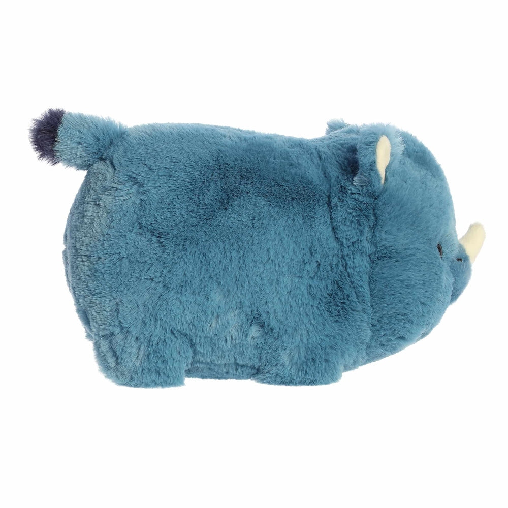 Aurora Spudsters Rio Rhino 10" plush toy, blue with yellow horn, soft plush fur, lying on its side.