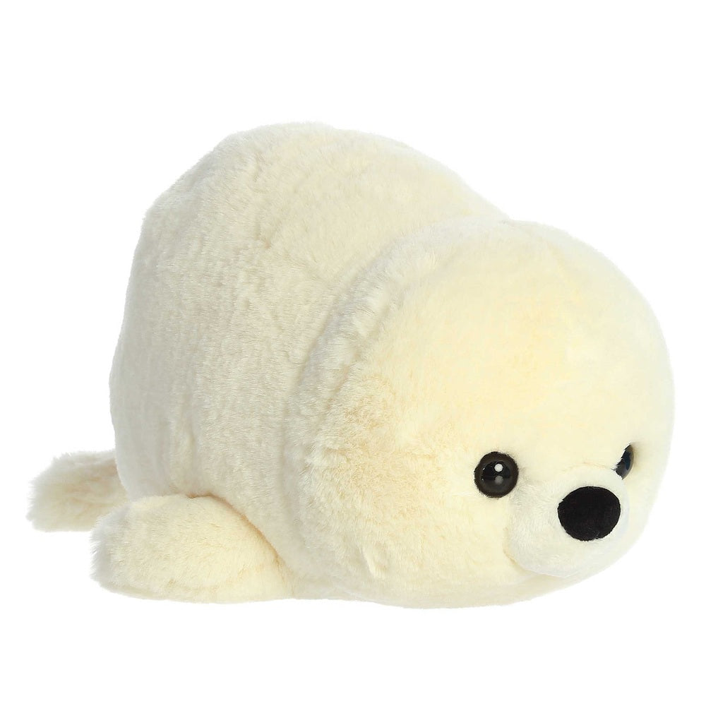 Aurora Spudsters Stella Seal 10 inch plush toy in soft cream fur, peacefully lying on its belly with black button eyes.