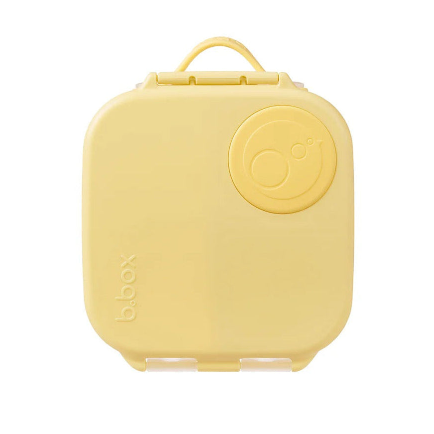 B.Box Mini Lunchbox yellow with a circular lid dial and handle, a compact kids' lunch container.