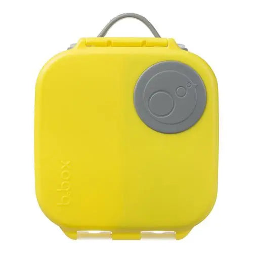 B.Box Mini Lunchbox yellow with gray circular lid and handle, showcasing its secure latch for kids' meals.