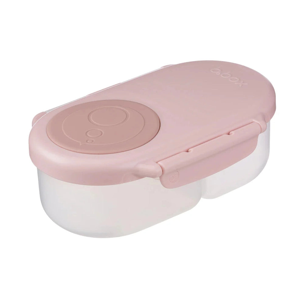 B.Box Snackbox in soft pink, dual-compartment lunch box with snap latch securing the lid.