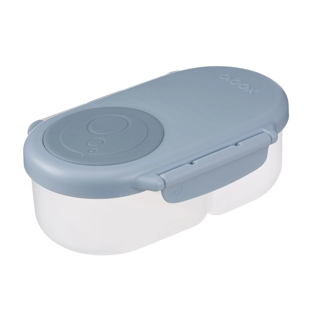 B.Box Snackbox dual-compartment lunch box with blue lid, latch closed over two clear sections.