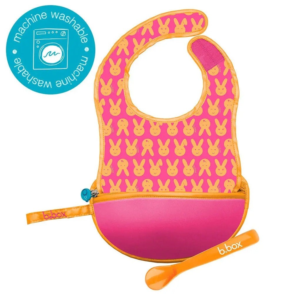 B.Box Travel Bib pink with orange trim and bunny print, zip pouch and attached spoon ready for mess-free meals.