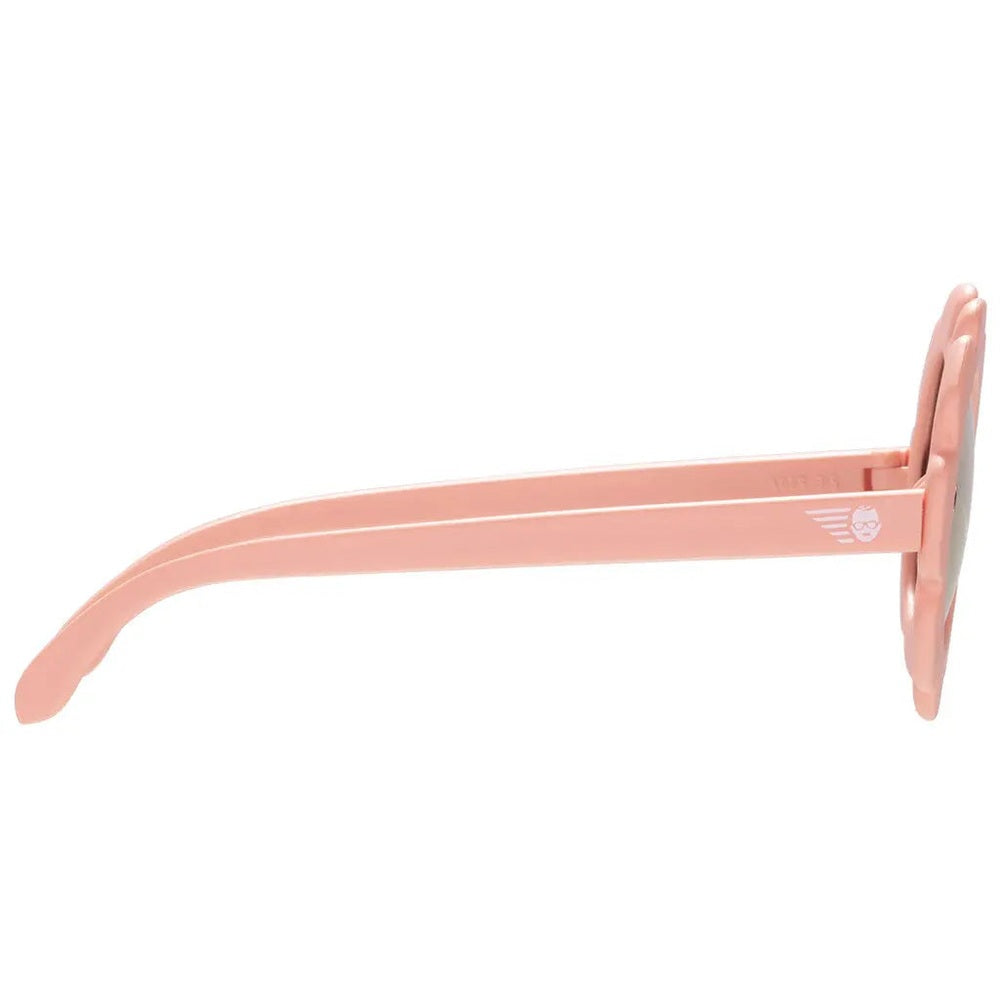 Babiators Flowers Shape Polarized Sunglasses Peachy Pink for kids, side view shows flower frame and logo on temple.