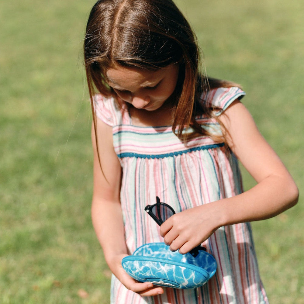 Babiators hard travel case with blue pool print and sunglasses