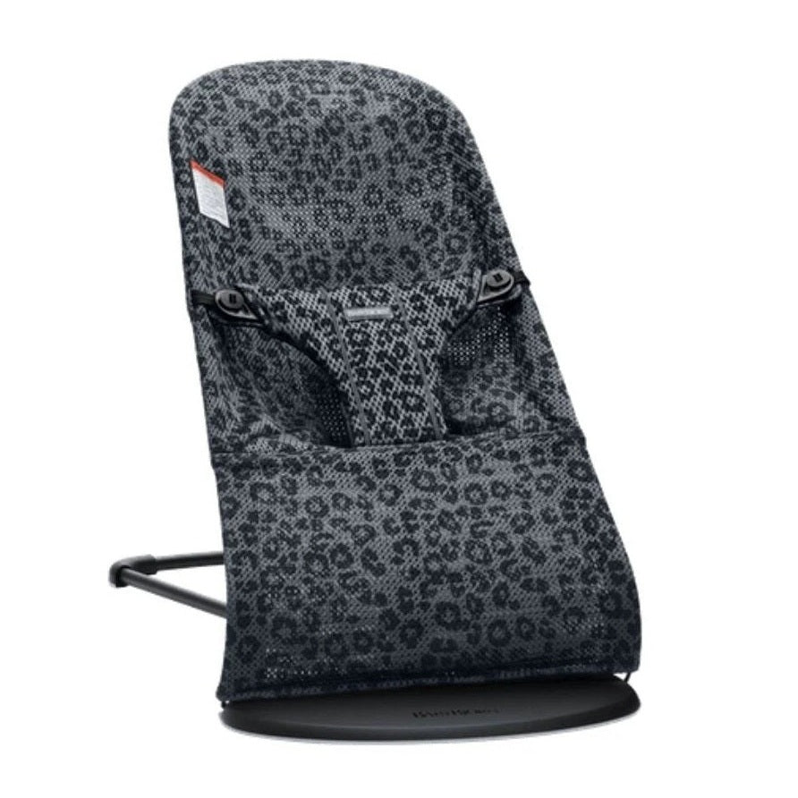 BabyBjörn Bouncer Bliss baby rocker in grey leopard fabric, mounted on a black base with curved frame.