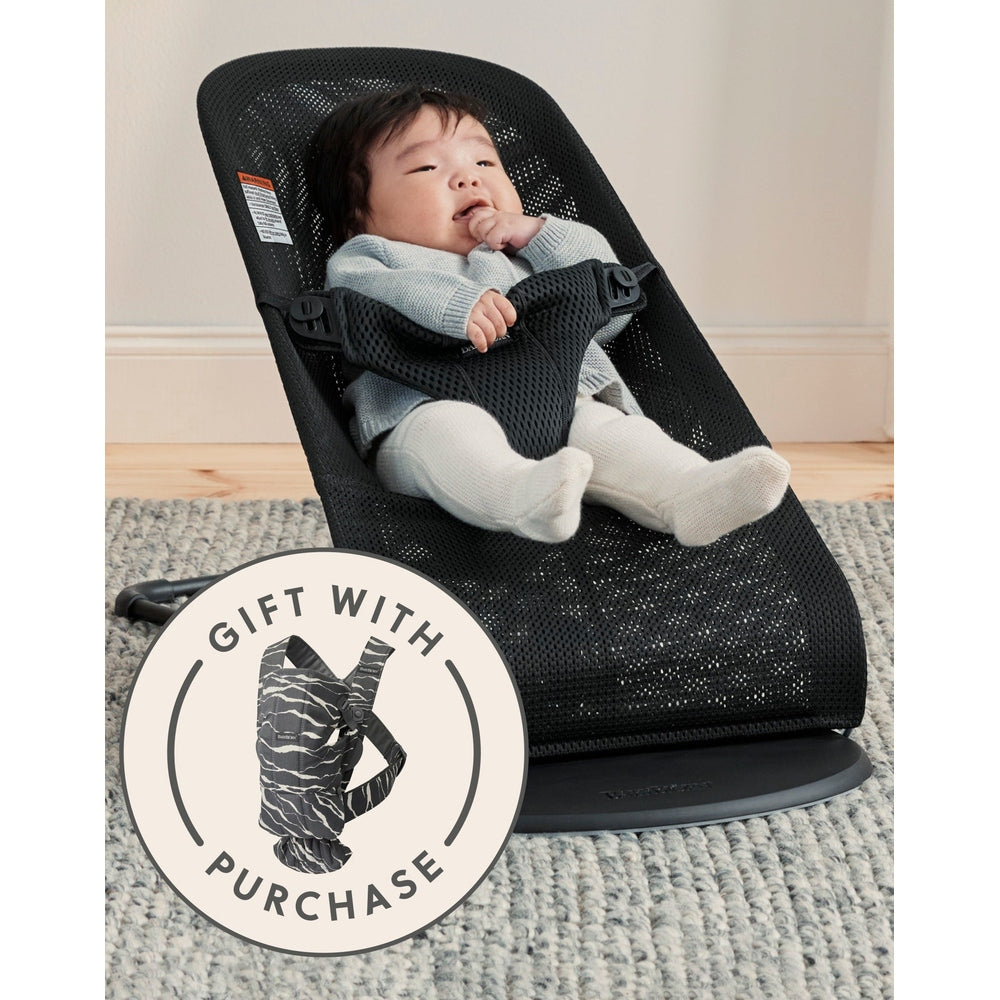 BABY BJÖRN Bouncer Bliss Black Mesh with baby in a reclined seat, securely strapped in; gift with purchase badge visible.